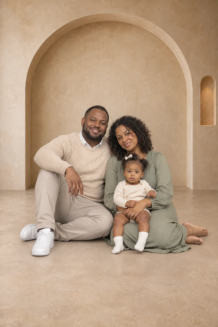 Family seated in a warm arch studio